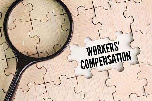 workers comp law puzzle with magnifying glass
