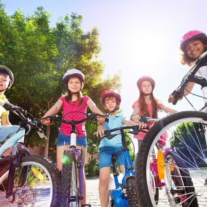 Happy children with their bicycles in summer park 2