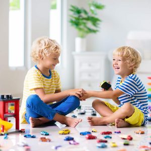 Kids play with toy cars. Children playing car toys