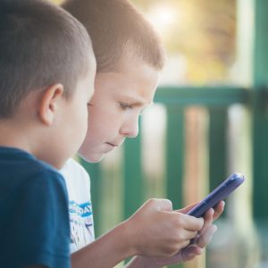 Boys playing games on mobile phone