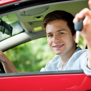 Teenager sitting in new car