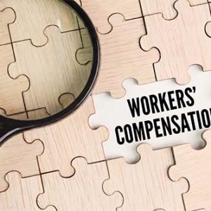 workers comp law puzzle with magnifying glass